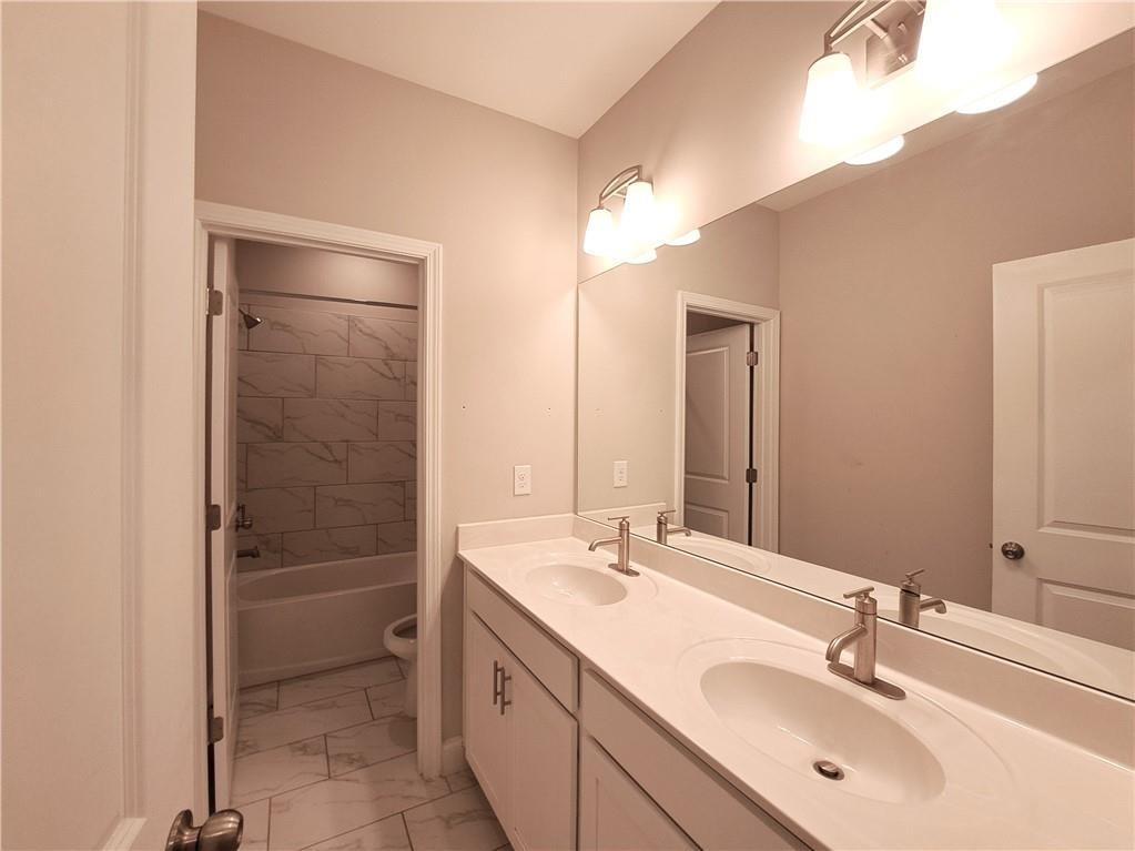 637 Stan Hope Lane Suwanee, GA 30024 - Photo 29 of 44 a bathroom with a sink double vanity and a mirror