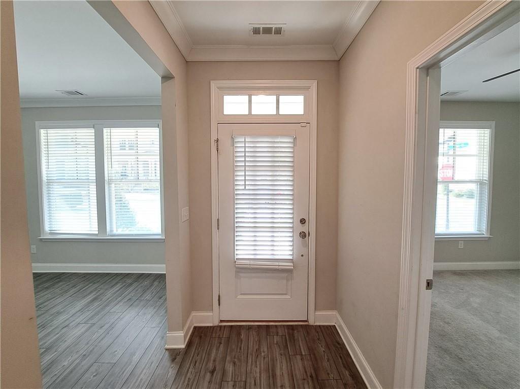 637 Stan Hope Lane Suwanee, GA 30024 - Photo 3 of 44 a view of an empty room with wooden floor and a window