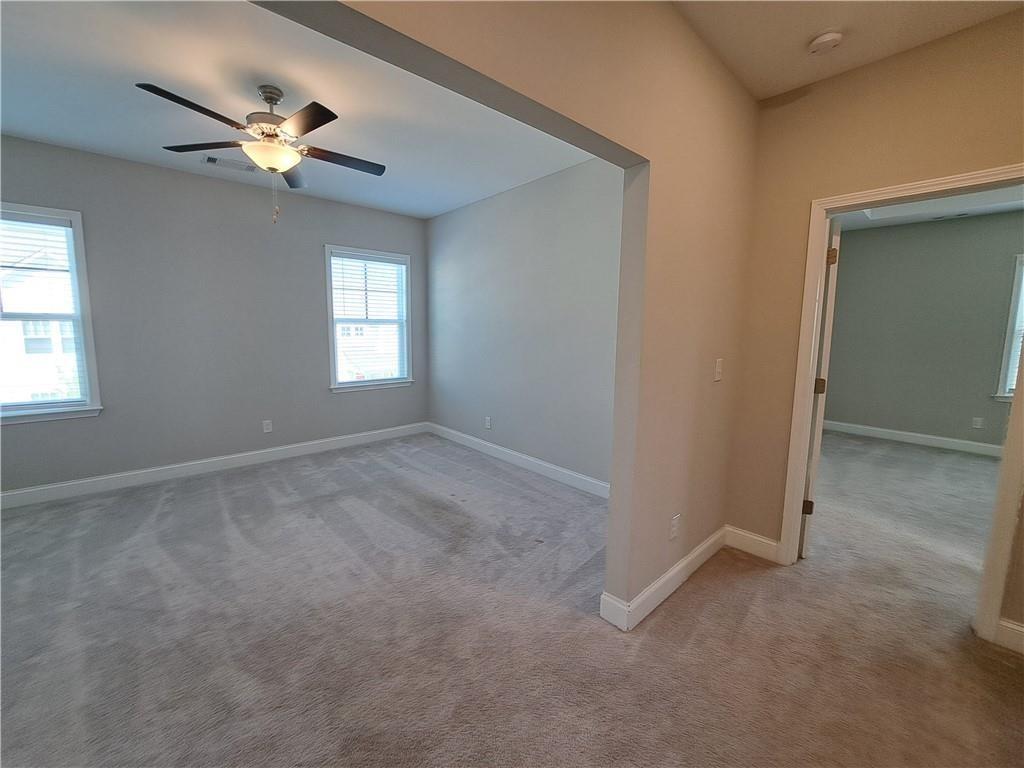 637 Stan Hope Lane Suwanee, GA 30024 - Photo 32 of 44 a view of a livingroom with a ceiling fan and window