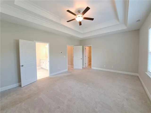 a spacious bathroom with a tub sink shower and mirror
