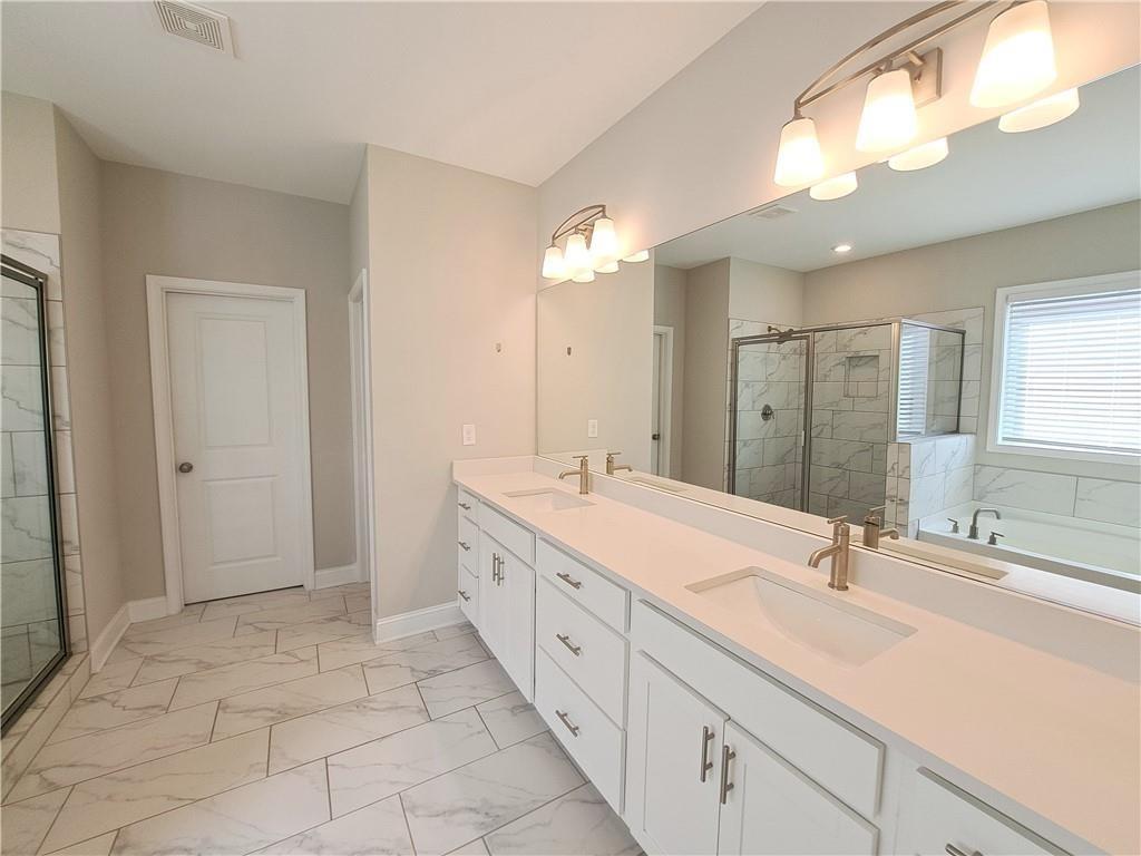 637 Stan Hope Lane Suwanee, GA 30024 - Photo 37 of 44 a spacious bathroom with a double vanity sink mirror and double