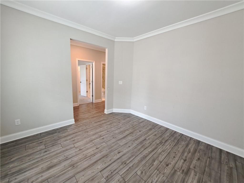 637 Stan Hope Lane Suwanee, GA 30024 - Photo 6 of 44 a view of an empty room with wooden floor and closet