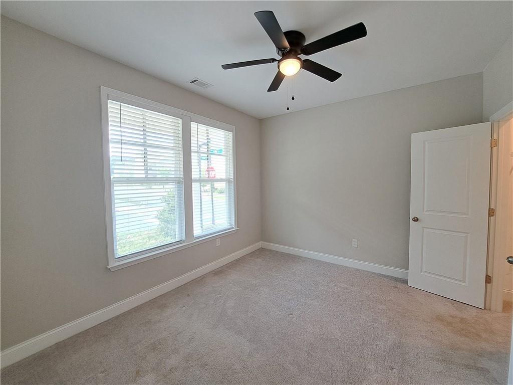 637 Stan Hope Lane Suwanee, GA 30024 - Photo 7 of 44 an empty room with a window and a fan