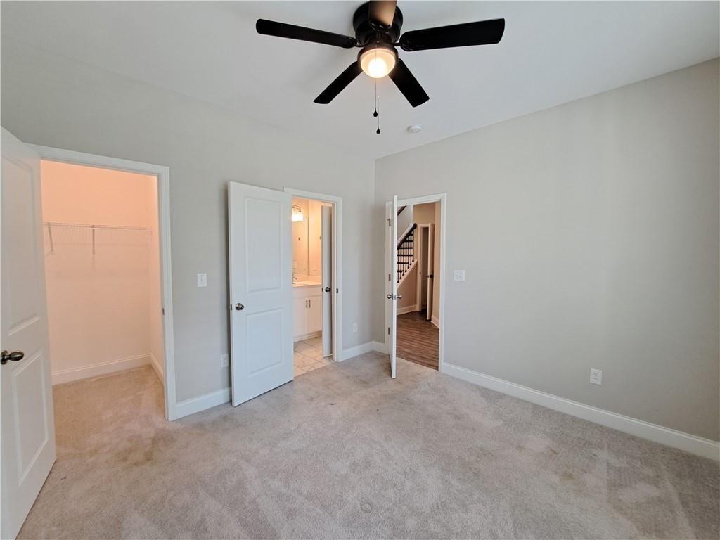 637 Stan Hope Lane Suwanee, GA 30024 - Photo 8 of 44 an empty room with closet and windows
