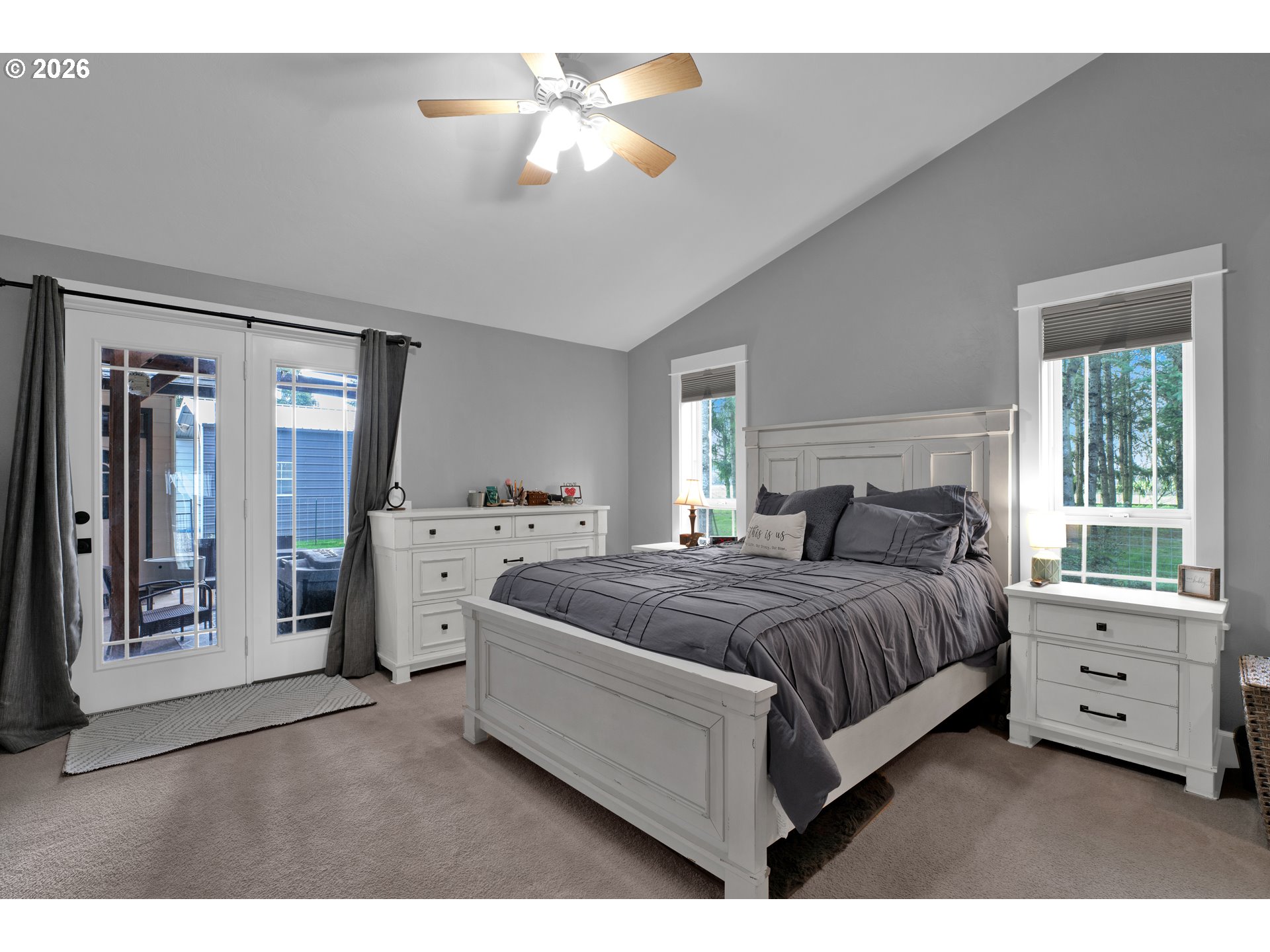 91606 Coburg Road Eugene, OR 97408 - Photo 19 of 30 a bedroom with a large bed and a chandelier