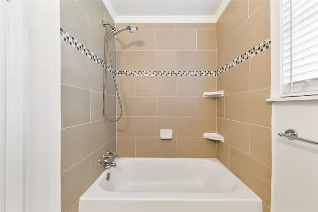 a bathroom with a white bath tub and a shower