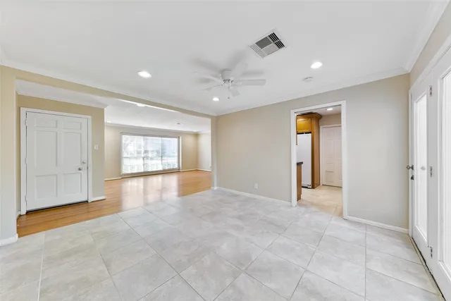 an empty room with windows and cabinet