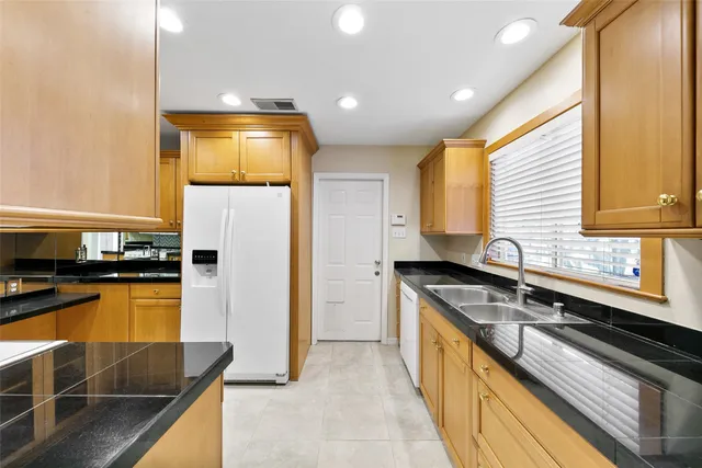 a kitchen with a sink stove and refrigerator