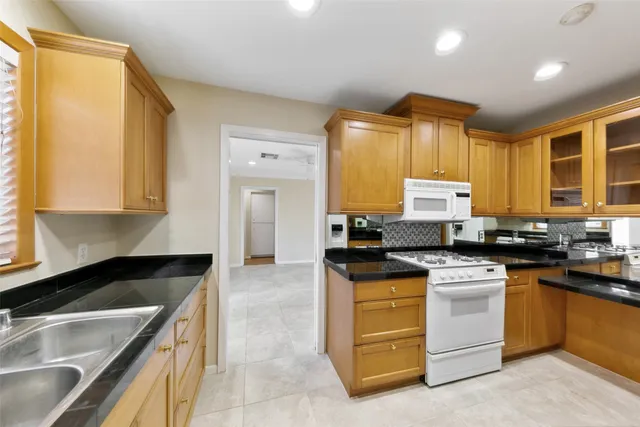 a kitchen with a stove a sink and a refrigerator