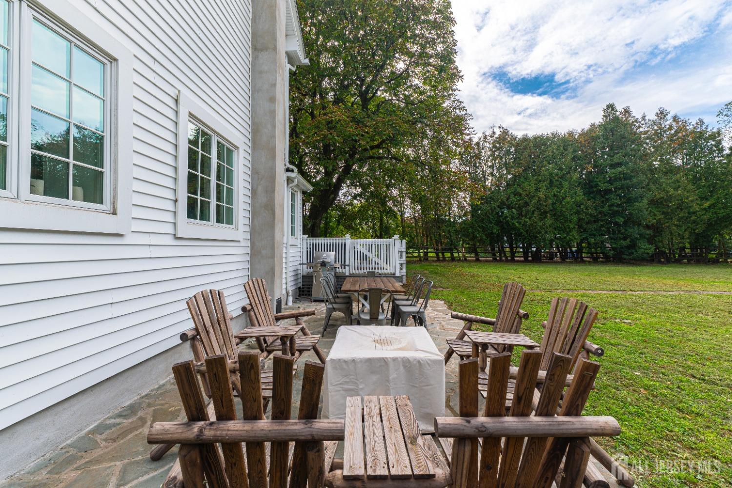 300 Blackpoint Road Neshanic Station, NJ 08853 - Photo 12 of 34 a view of a patio with table and chairs with wooden floor and fence