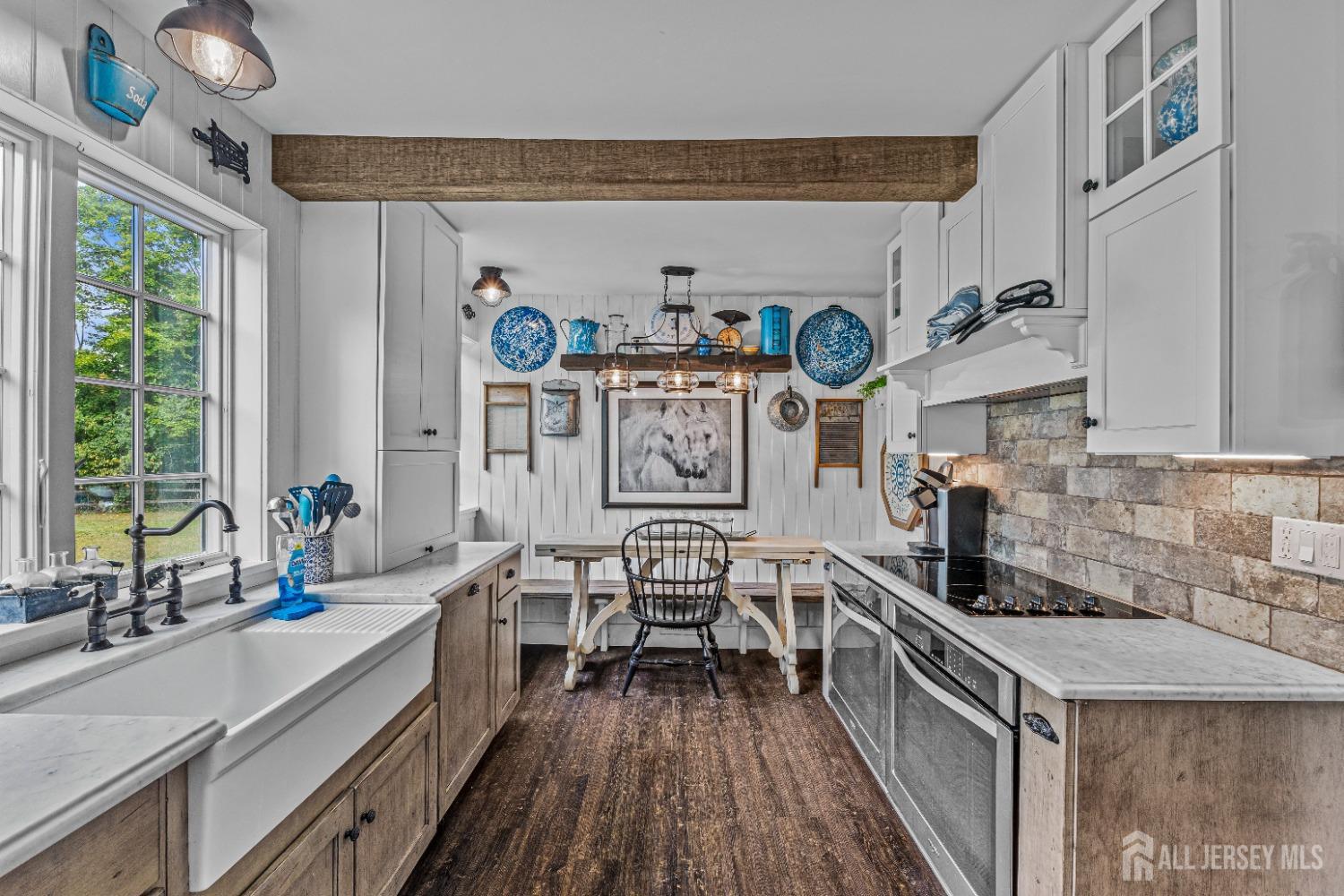 300 Blackpoint Road Neshanic Station, NJ 08853 - Photo 31 of 34 a view of a kitchen with kitchen island a large window cabinets stainless steel appliances and a large window