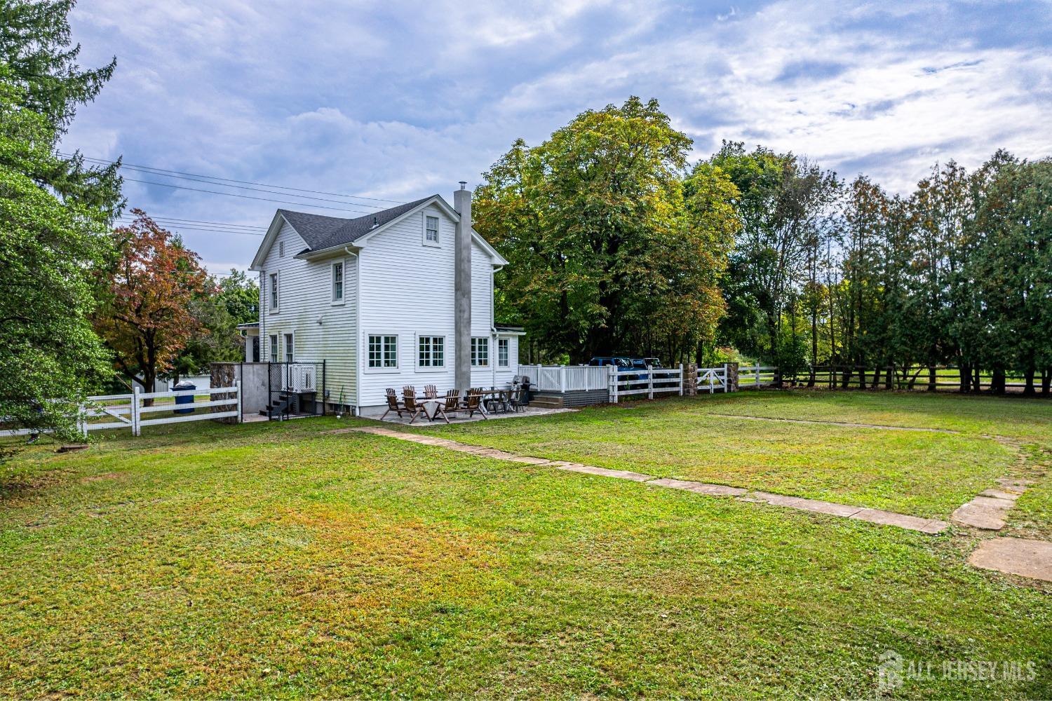 300 Blackpoint Road Neshanic Station, NJ 08853 - Photo 7 of 34 a view of a swimming pool with lawn chairs under an umbrella