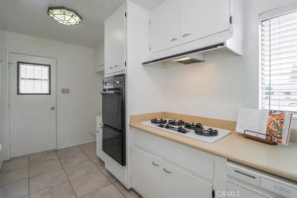 a kitchen with a refrigerator and a stove