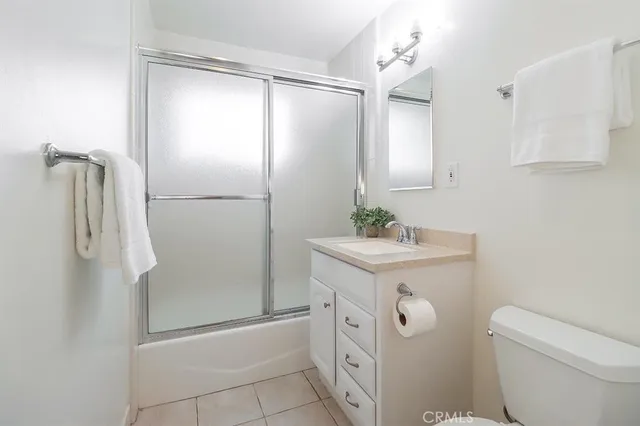 a bathroom with a shower a sink and a mirror