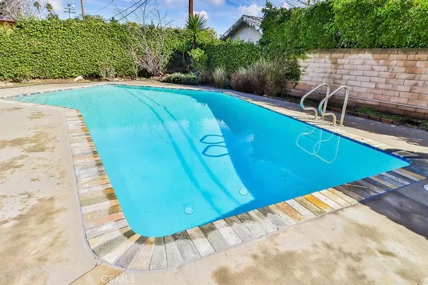 a view of a swimming pool with a yard