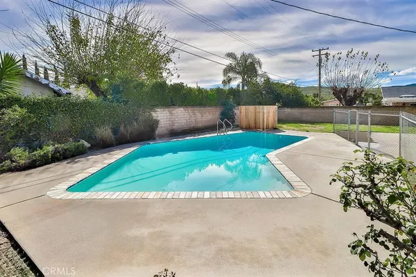 a view of backyard with swimming pool