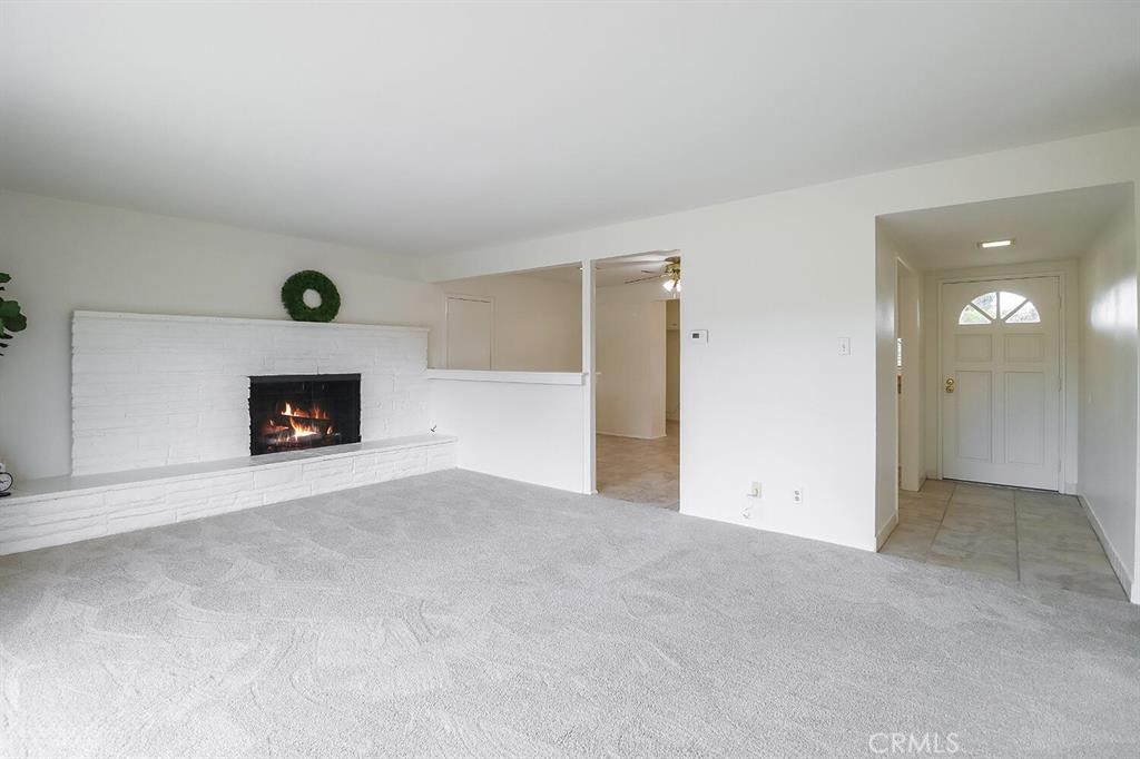 1870 Burch Avenue Simi Valley, CA 93063 - Photo 3 of 20 a view of an empty room with a fireplace and a window
