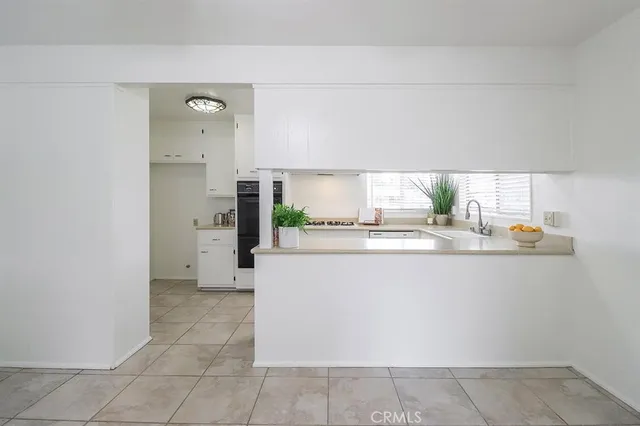 a kitchen with stainless steel appliances a refrigerator and a stove