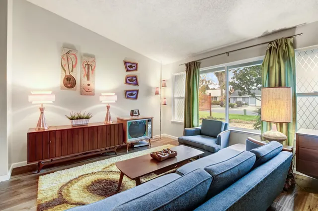 a living room with furniture and a table