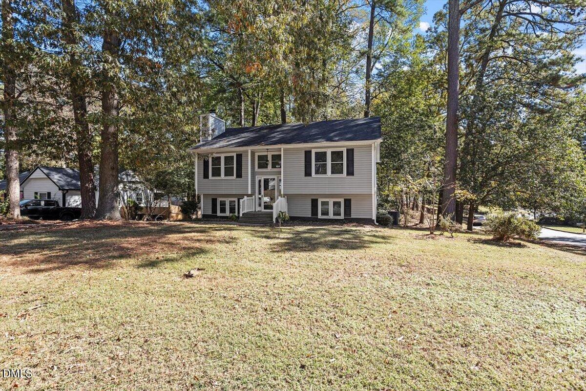 100 Brook Rock Lane Garner, NC 27529 - Photo 1 of 33 a front view of a house with a yard covered with snow and trees
