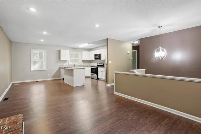 a view of a kitchen with a sink and a large window