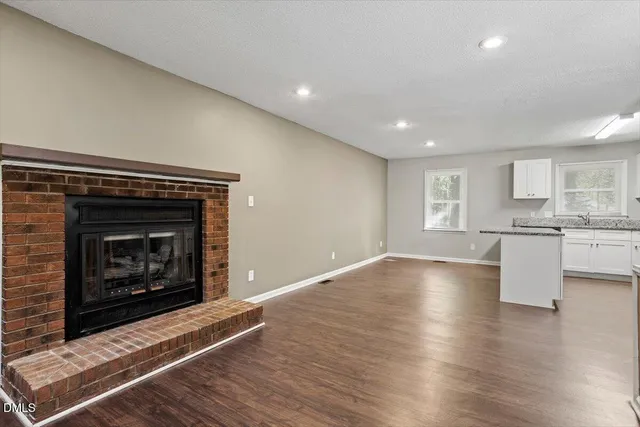 a view of kitchen with fireplace and wooden floor