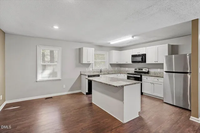 a kitchen with cabinets and stainless steel appliances