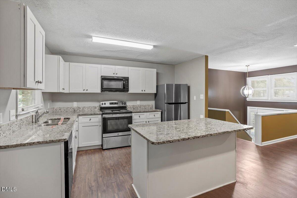 100 Brook Rock Lane Garner, NC 27529 - Photo 15 of 33 a kitchen with granite countertop a stove and a refrigerator