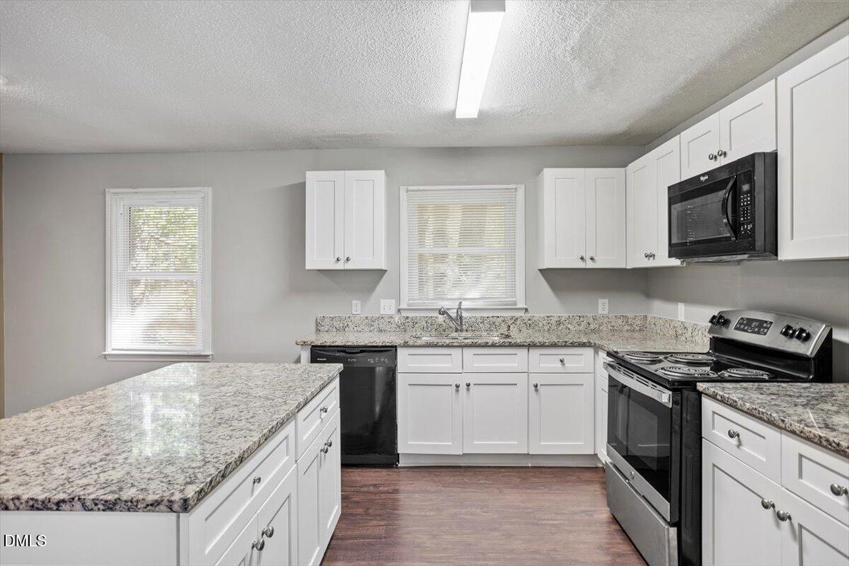 100 Brook Rock Lane Garner, NC 27529 - Photo 17 of 33 a kitchen with stainless steel appliances granite countertop a sink stove and microwave