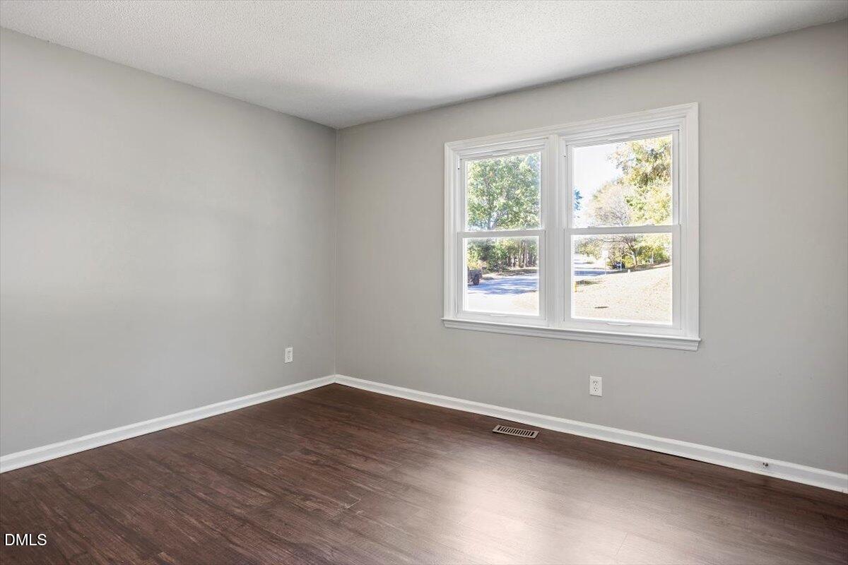 100 Brook Rock Lane Garner, NC 27529 - Photo 21 of 33 an empty room with wooden floor and windows