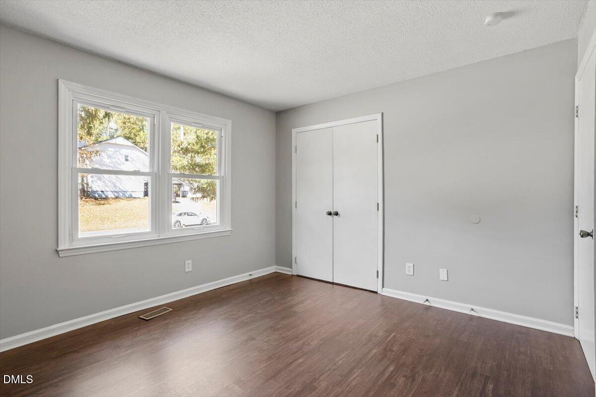 100 Brook Rock Lane Garner, NC 27529 - Photo 22 of 33 an empty room with wooden floor and windows