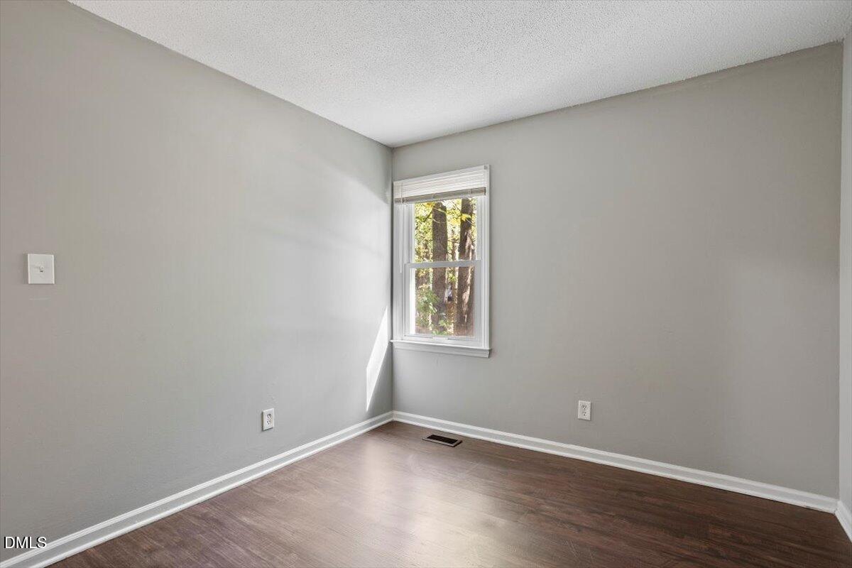 100 Brook Rock Lane Garner, NC 27529 - Photo 24 of 33 an empty room with wooden floor and window