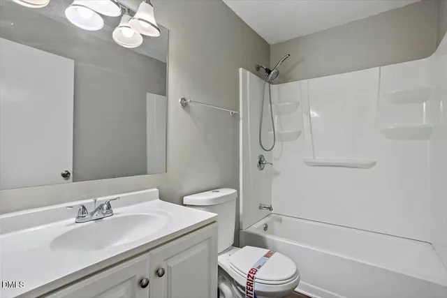 a bathroom with a sink toilet vanity and shower