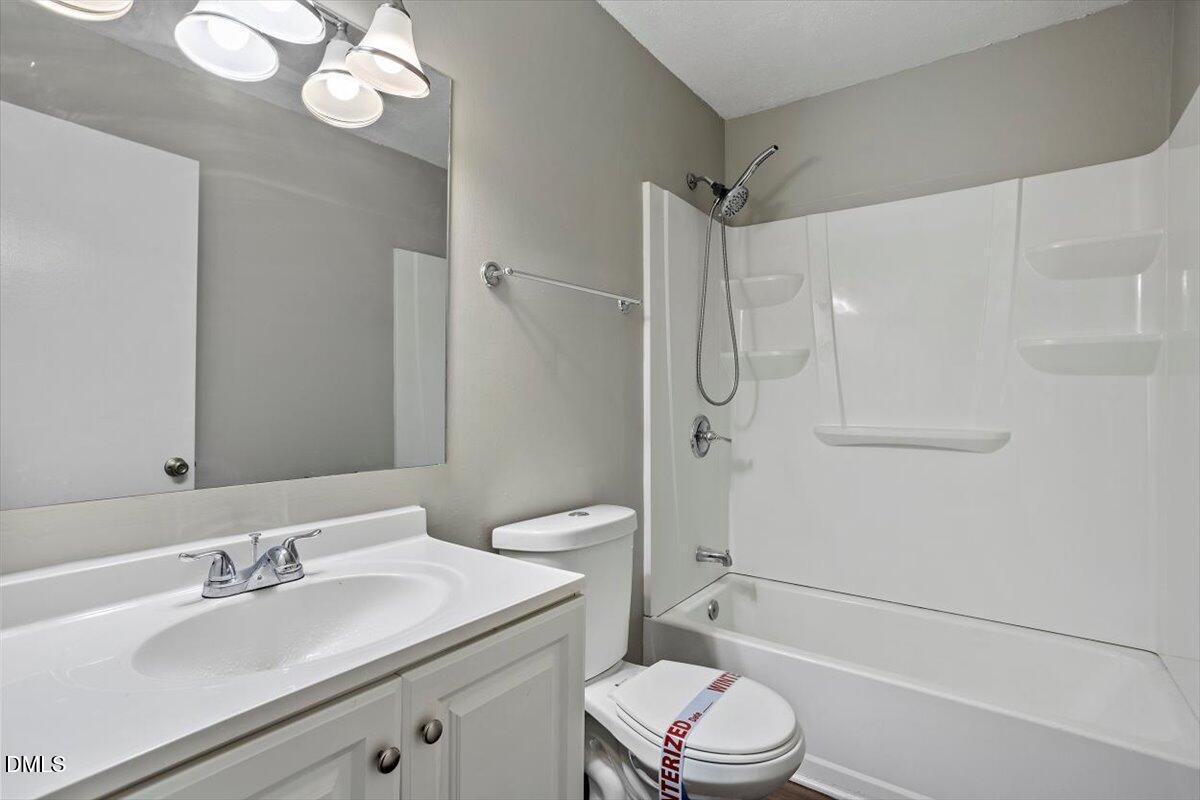 100 Brook Rock Lane Garner, NC 27529 - Photo 25 of 33 a bathroom with a sink toilet vanity and shower