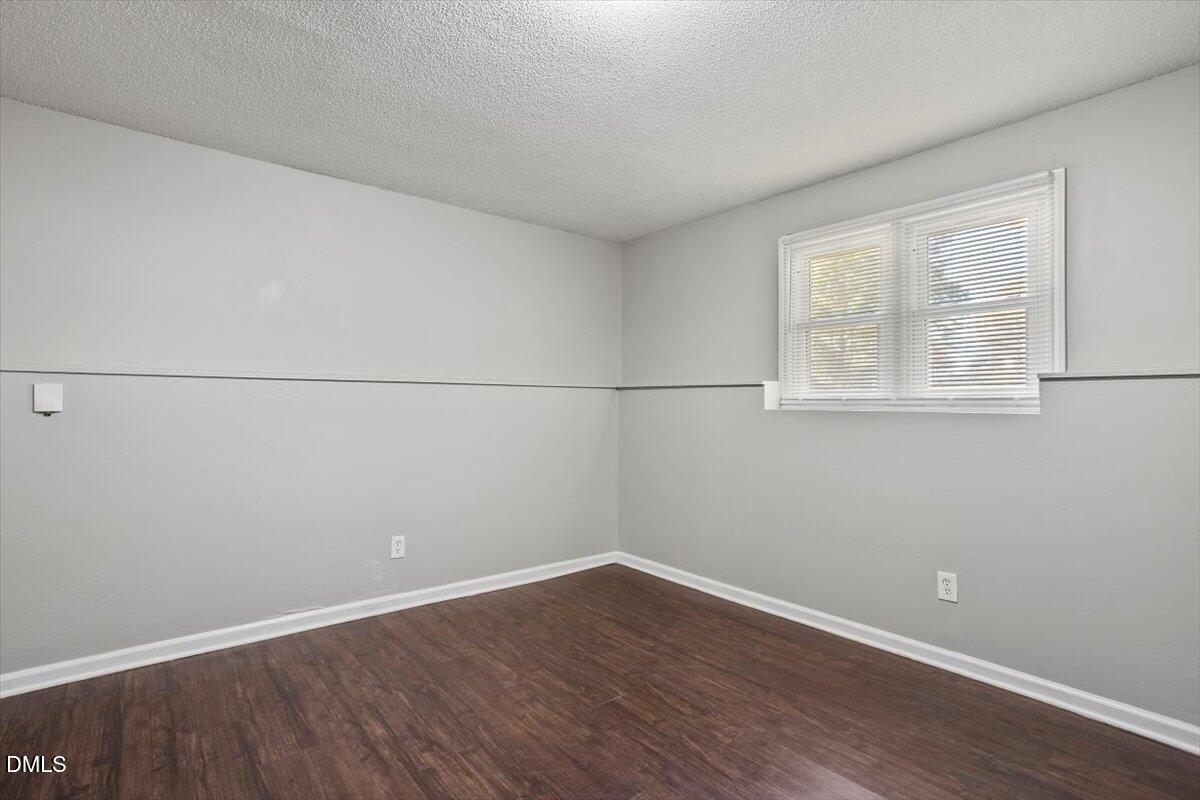 100 Brook Rock Lane Garner, NC 27529 - Photo 26 of 33 an empty room with wooden floor and windows