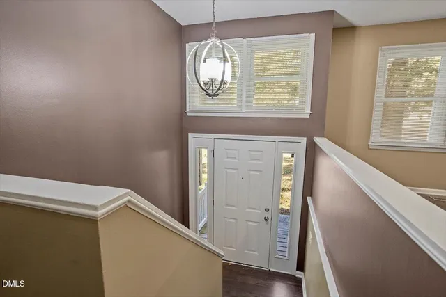 a view of hallway with wooden floor