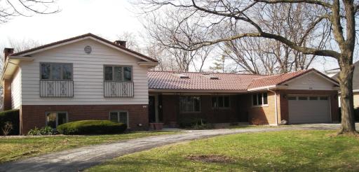 268 Longcommon Road Riverside, IL 60546 - Photo 1 of 1 a front view of a house with a yard and garage