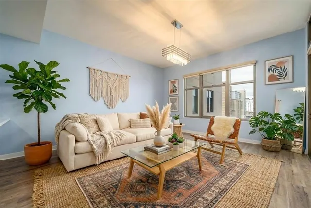 a living room with furniture potted plant and a table