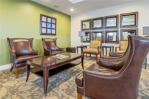 a living room with furniture a flat screen tv and a large window