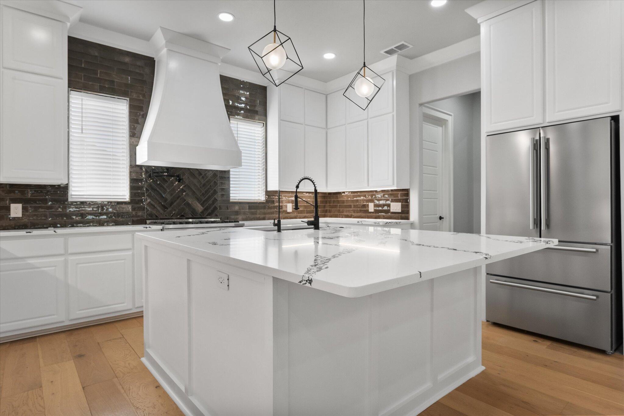 7516 57th Street Lubbock, TX 79407 - Photo 12 of 35 a kitchen with stainless steel appliances granite countertop a sink a stove and a refrigerator