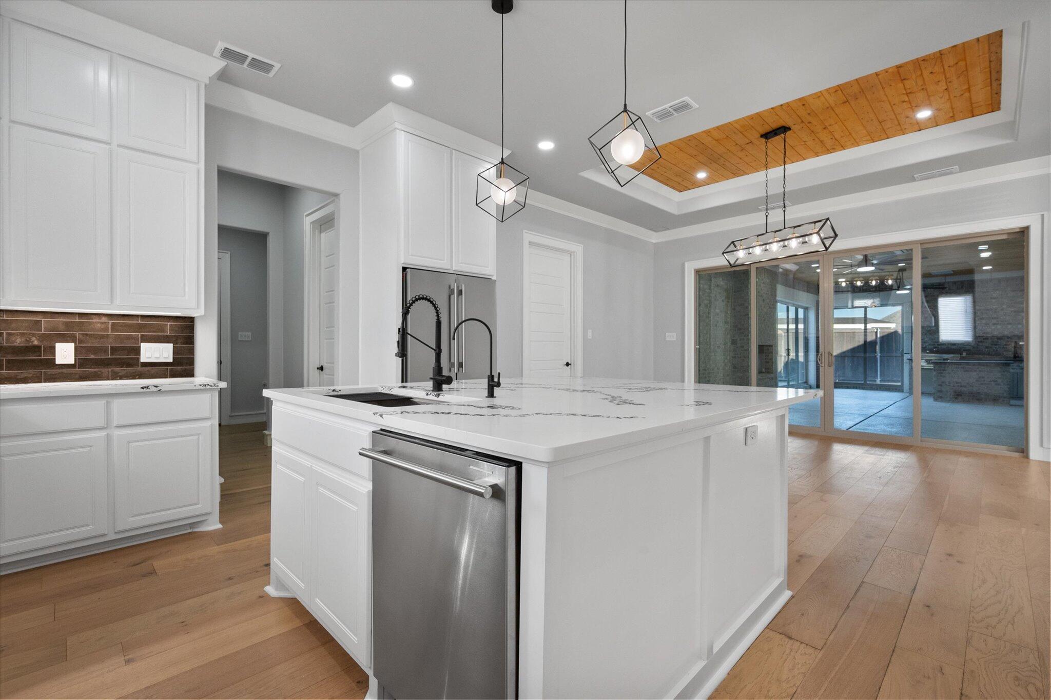 7516 57th Street Lubbock, TX 79407 - Photo 15 of 35 a kitchen with a sink and refrigerator