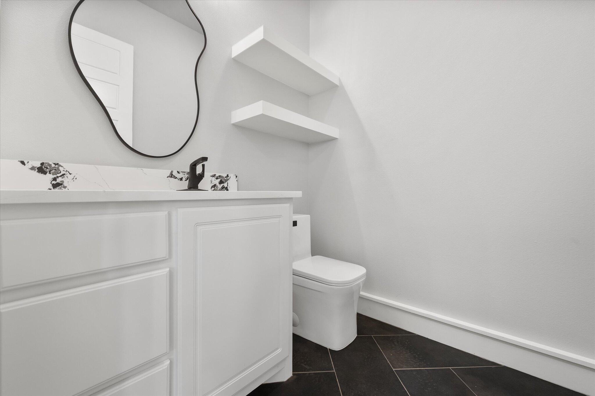 7516 57th Street Lubbock, TX 79407 - Photo 16 of 35 a bathroom with a sink and a mirror