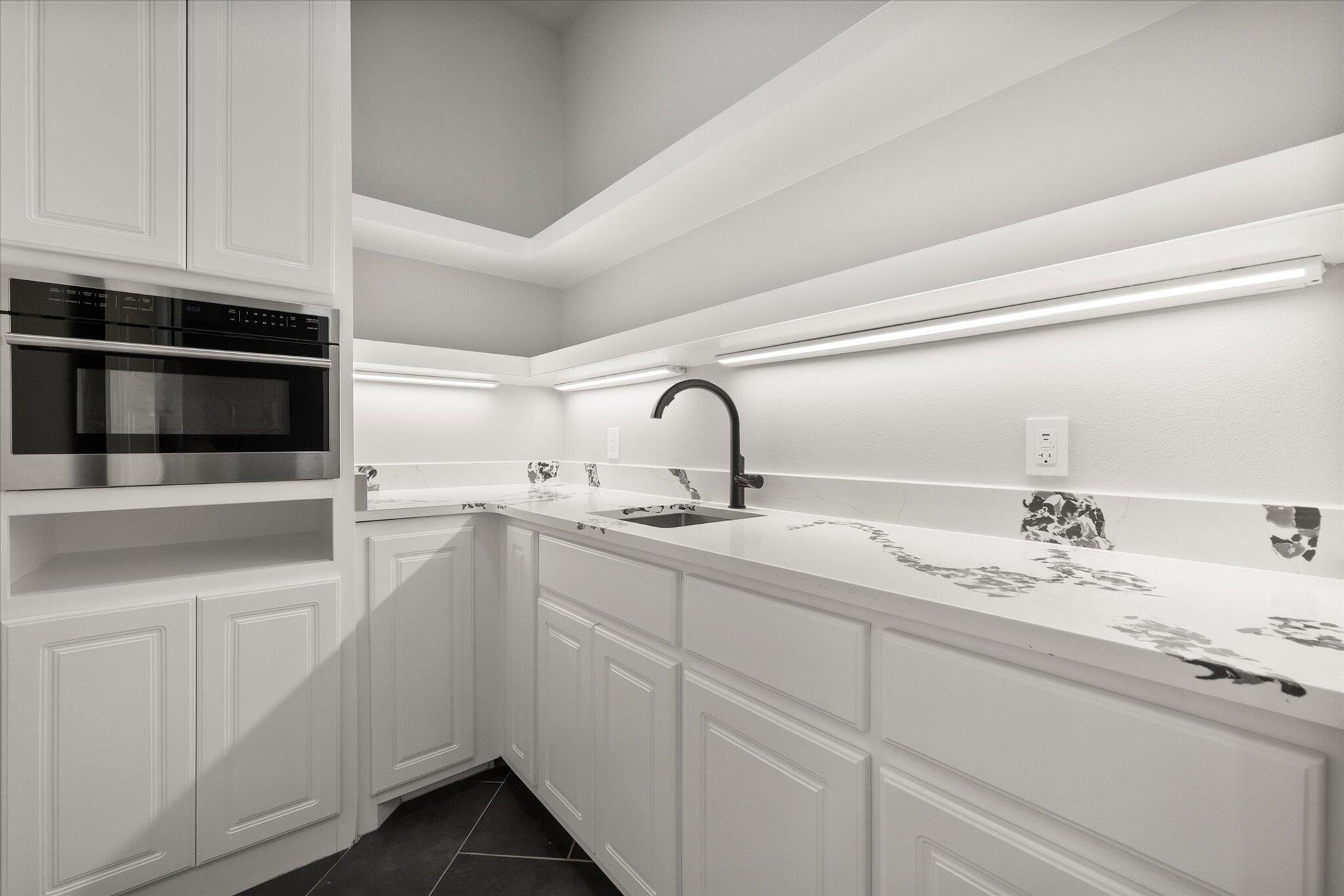 7516 57th Street Lubbock, TX 79407 - Photo 17 of 35 a kitchen with appliances a sink and cabinets