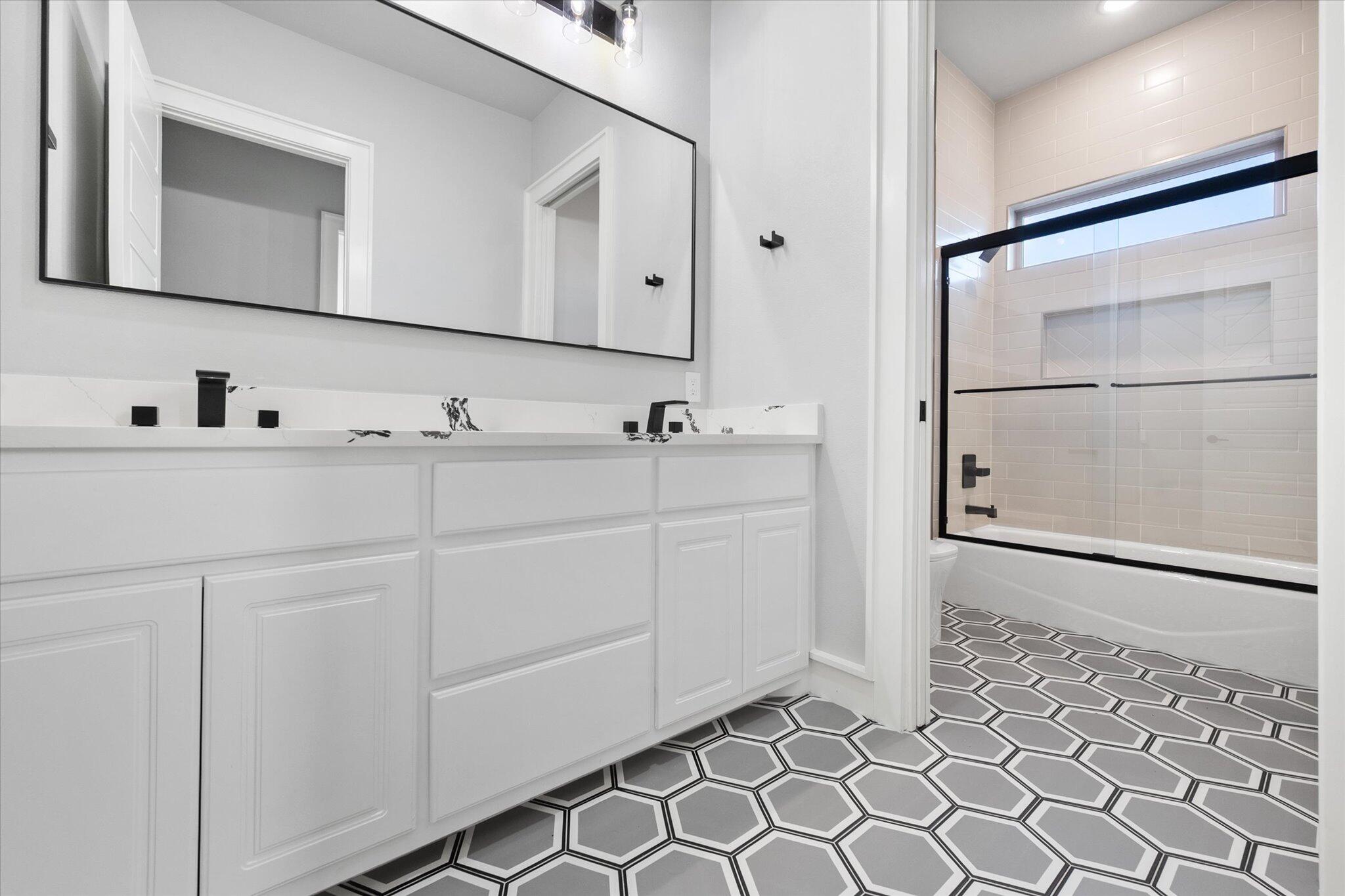 7516 57th Street Lubbock, TX 79407 - Photo 18 of 35 a bathroom with a sink and a mirror