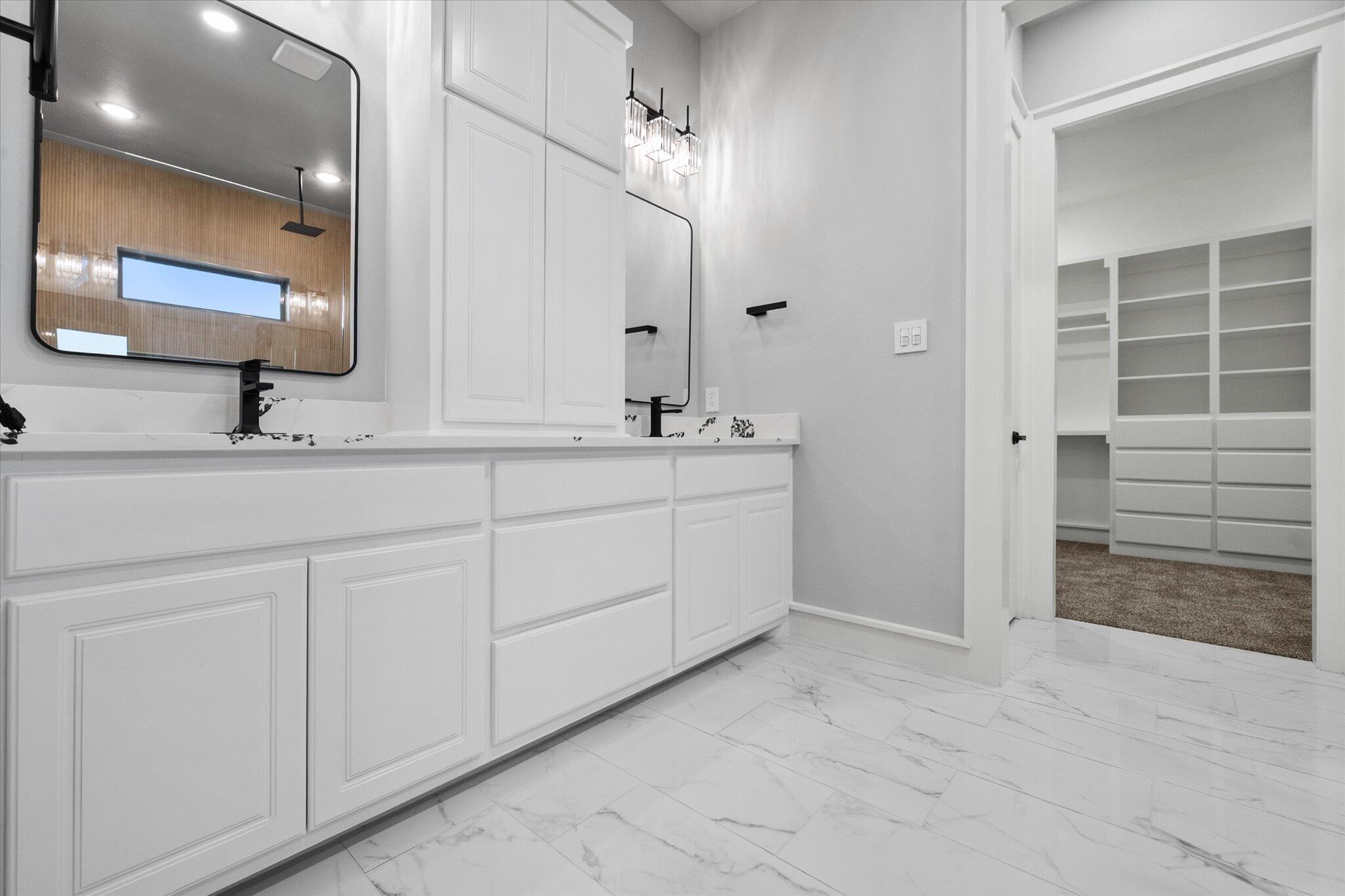 7516 57th Street Lubbock, TX 79407 - Photo 25 of 35 a bathroom with a sink and a mirror