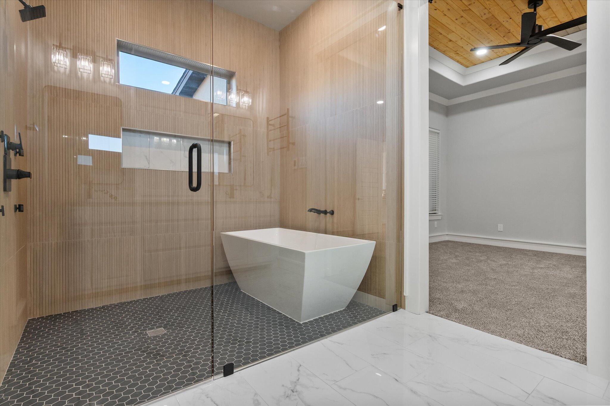 7516 57th Street Lubbock, TX 79407 - Photo 26 of 35 a bathroom with a bathtub and shower