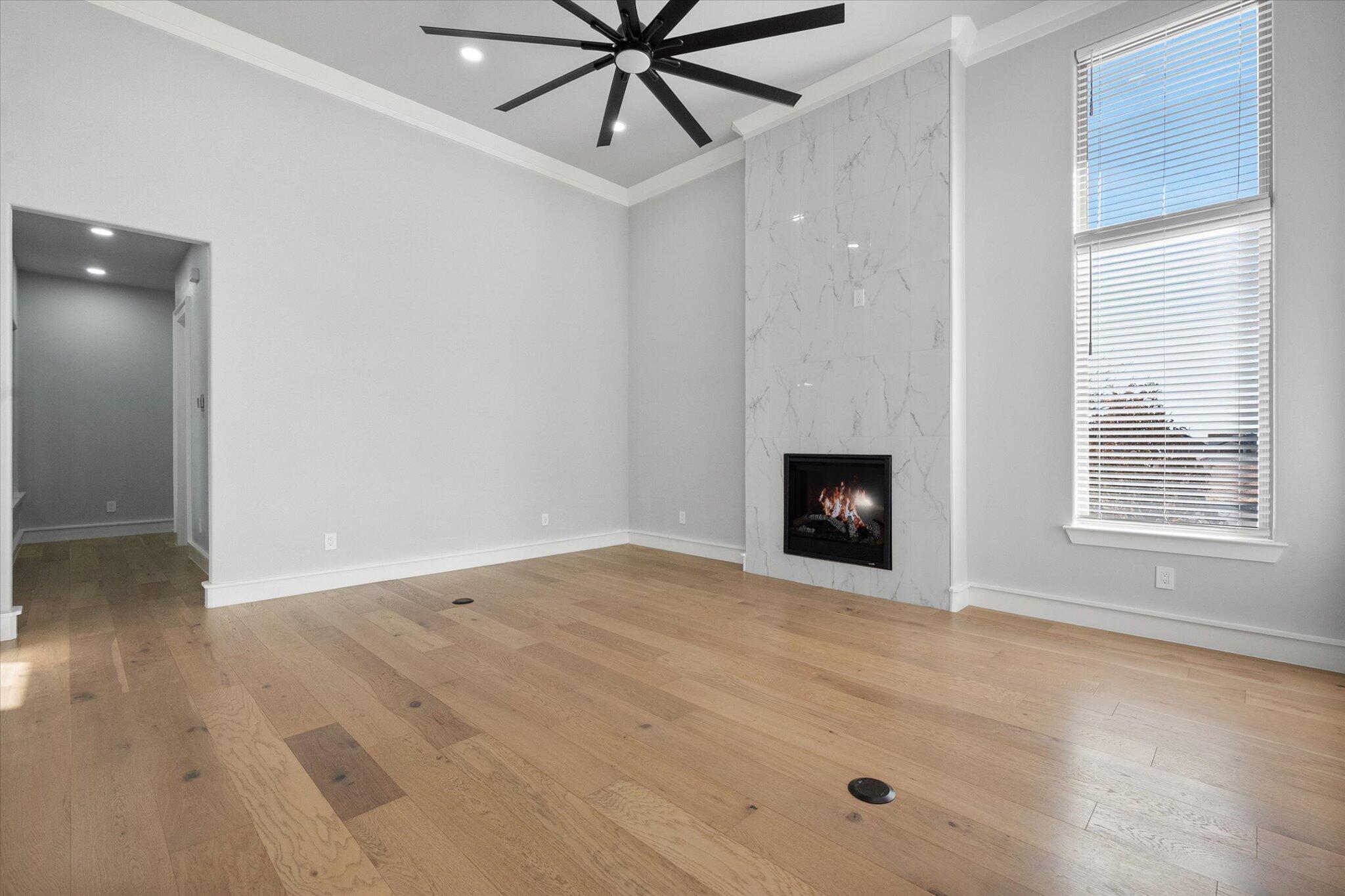 7516 57th Street Lubbock, TX 79407 - Photo 5 of 35 a view of an empty room with a window and fireplace