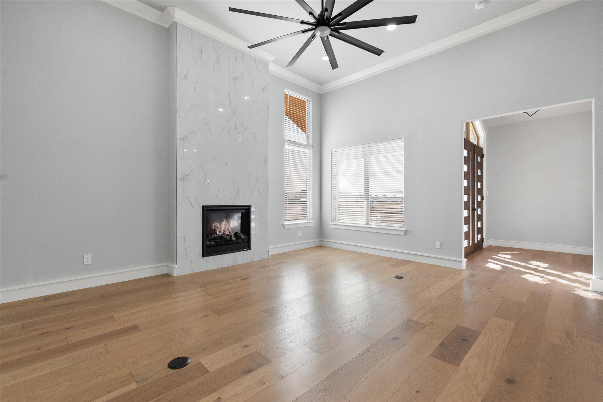 7516 57th Street Lubbock, TX 79407 - Photo 8 of 35 a view of an empty room with a window and wooden floor