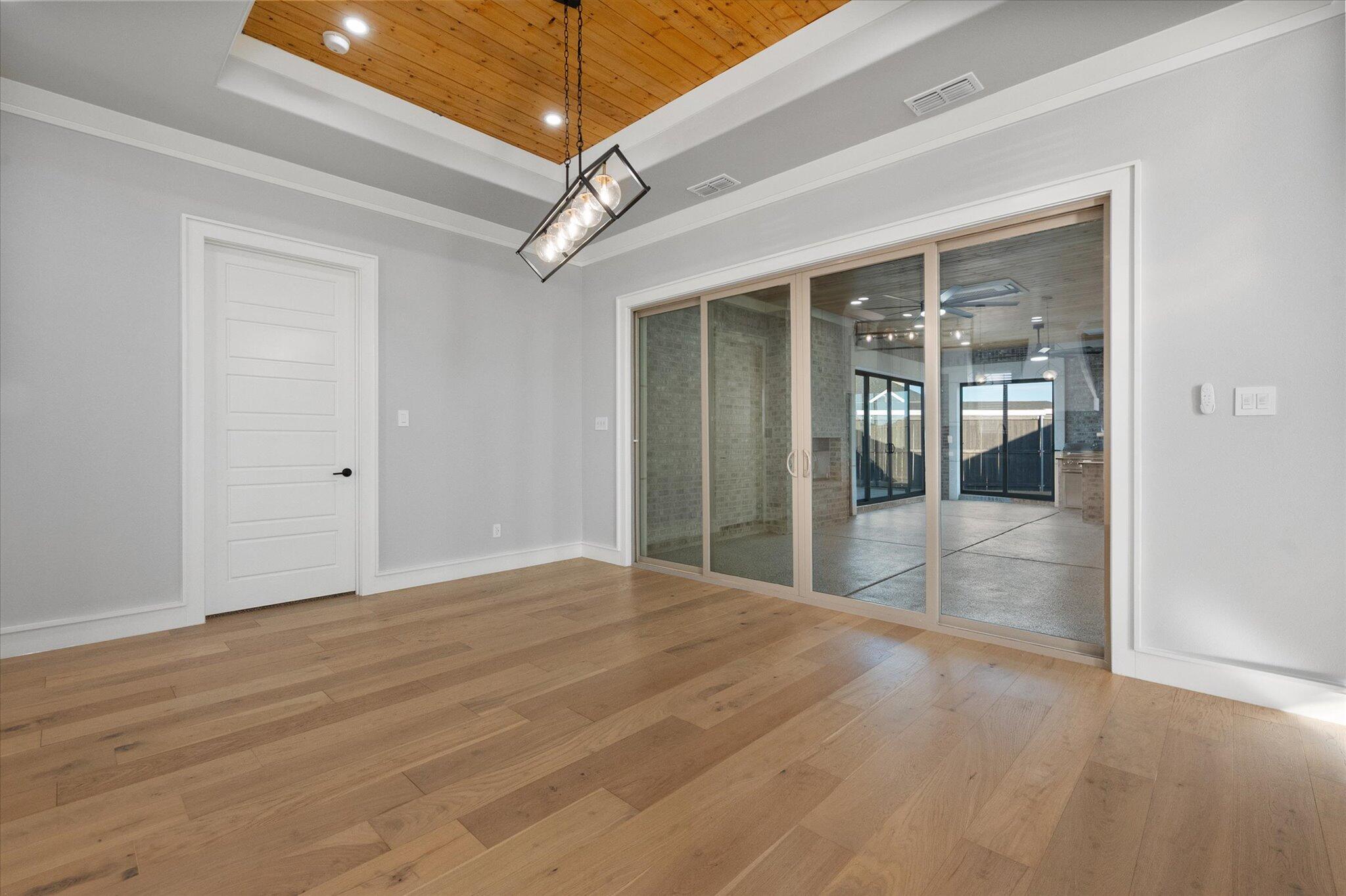 7516 57th Street Lubbock, TX 79407 - Photo 9 of 35 a view of an empty room with glass door and windows
