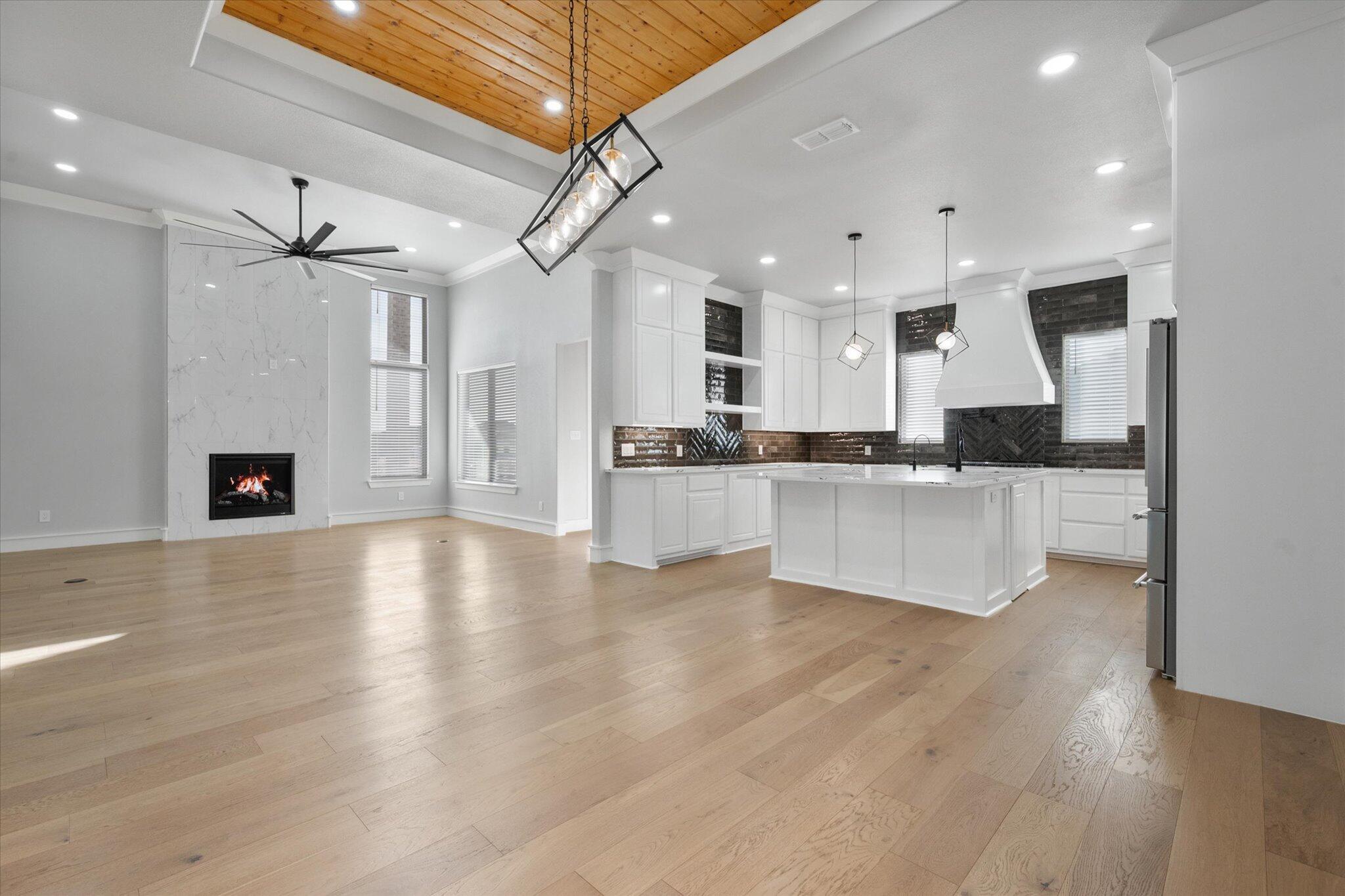7516 57th Street Lubbock, TX 79407 - Photo 10 of 35 a view of kitchen with cabinets stainless steel appliances and wooden floor